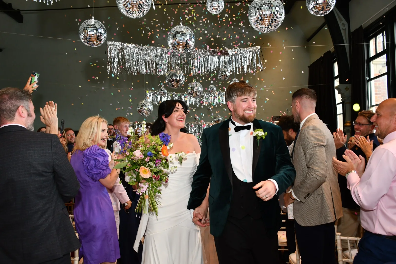 Aimee and Jamie celebrating beneath confetti