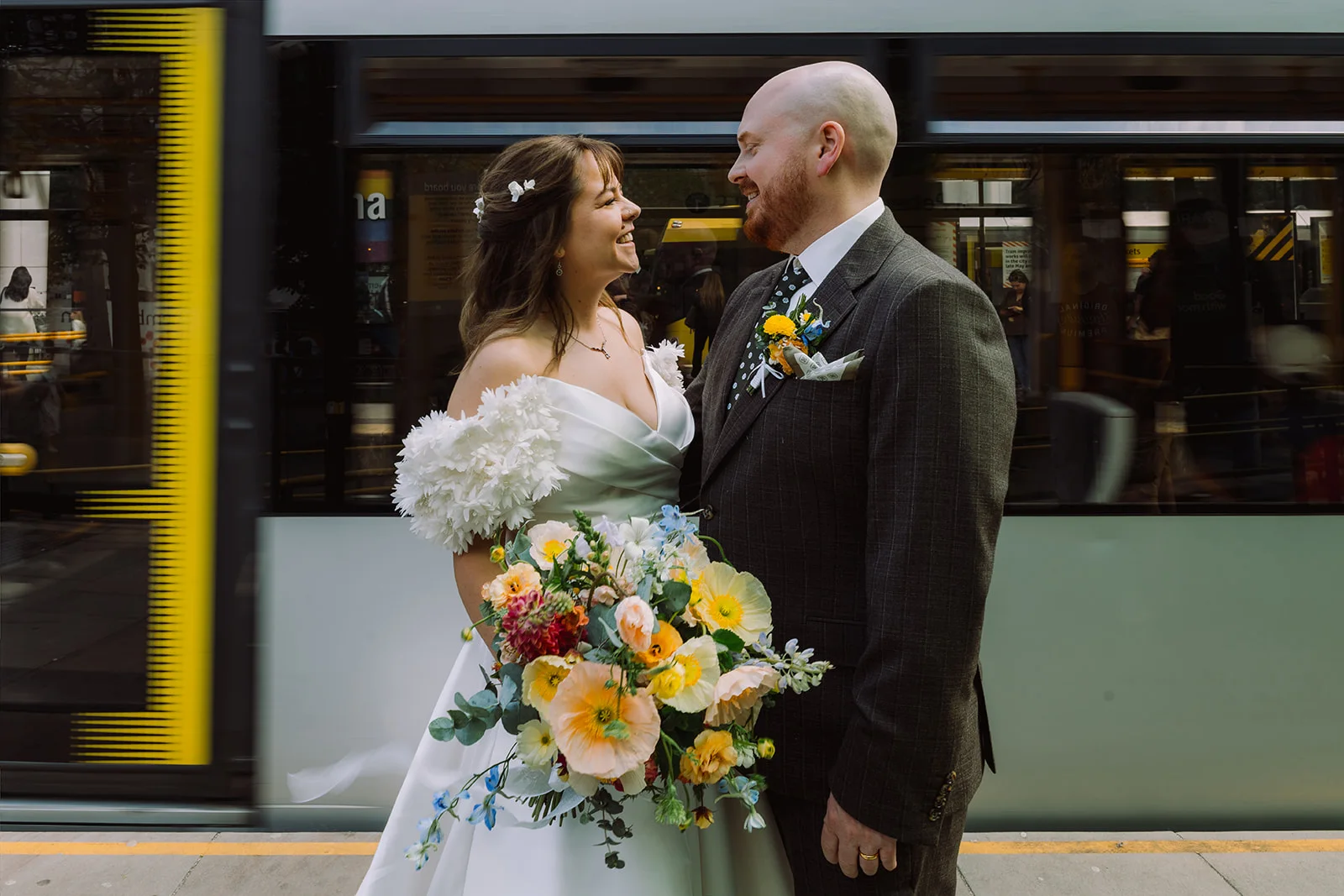 Laura and Bill beside a passing Manchester tram
