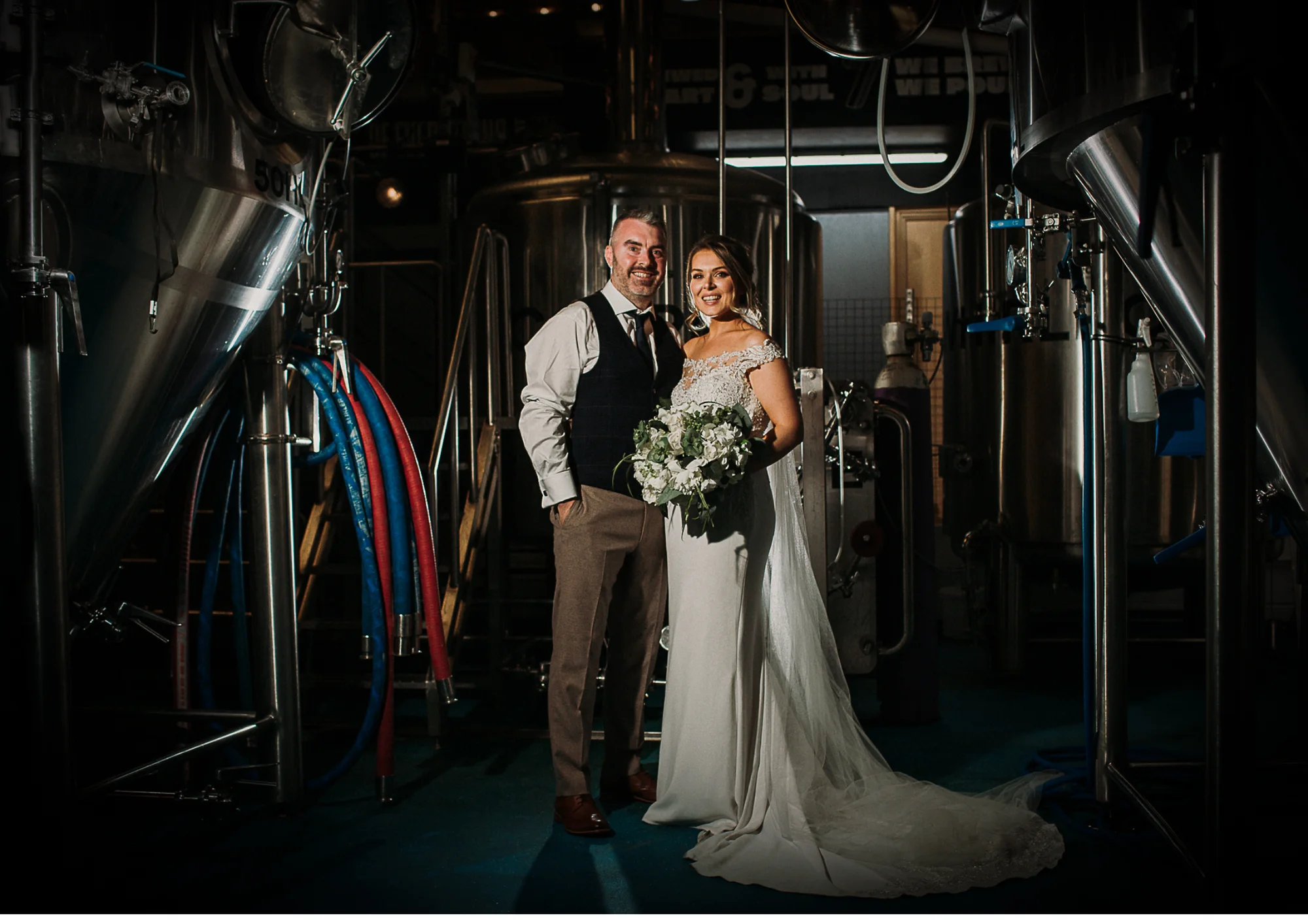 Paul and Jade together among the brewery equipment