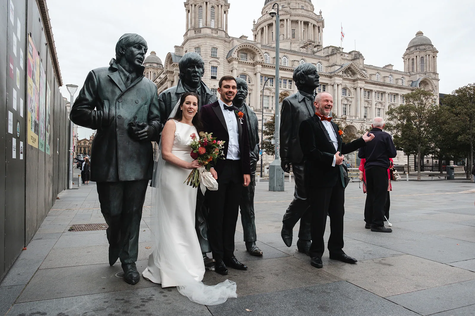 Sabine and Ryan smiling beside the Beatles statues in Liverpool