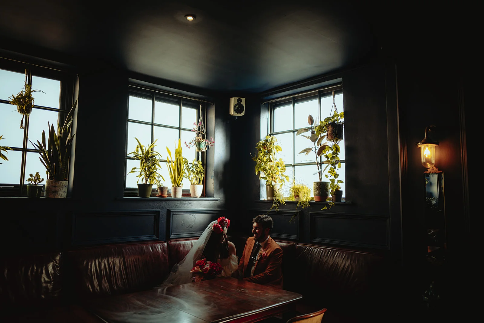Gwen and Nate sharing a quiet moment together in a dark bar