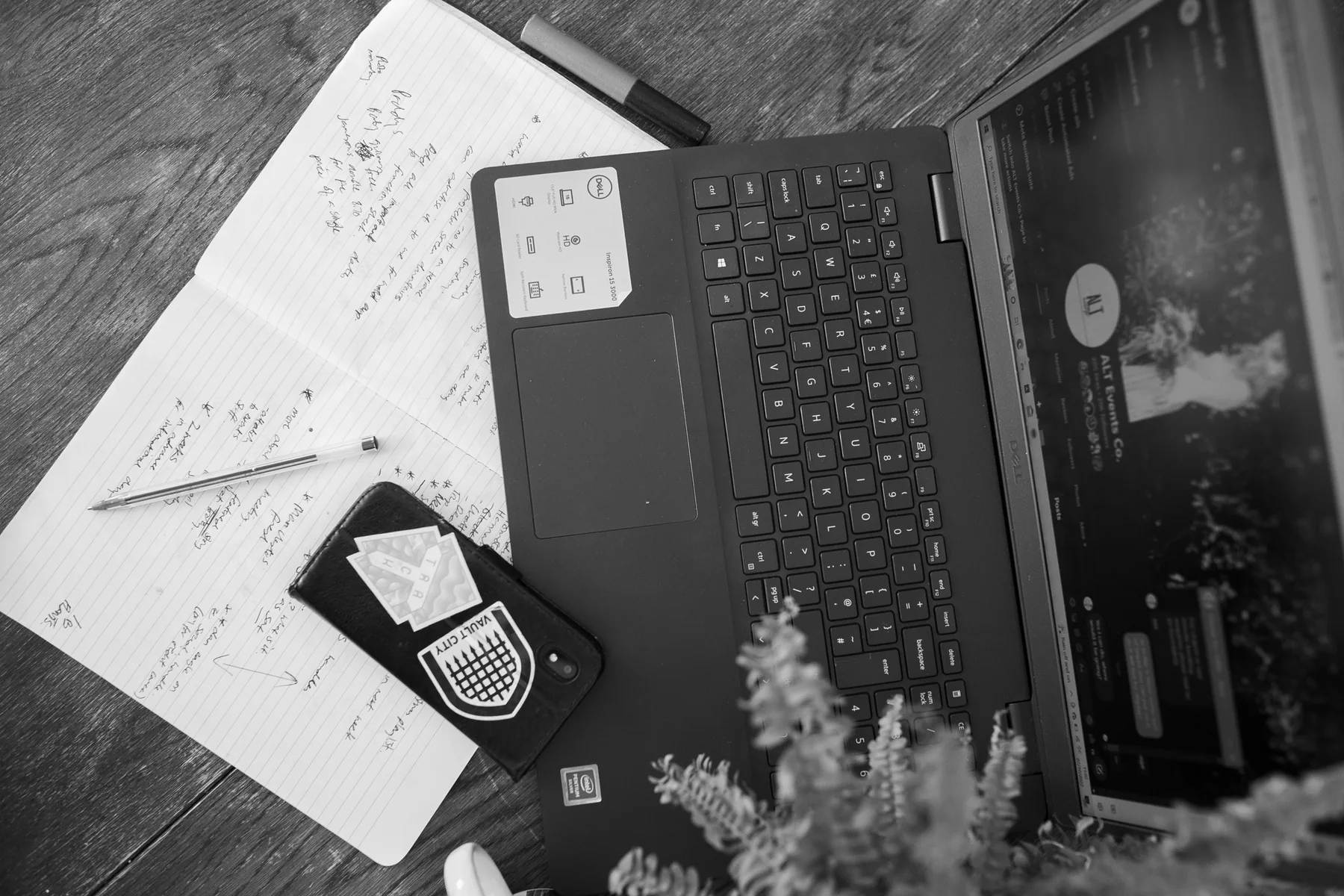 Wedding planning notes, a phone and Beth’s laptop on a work table
