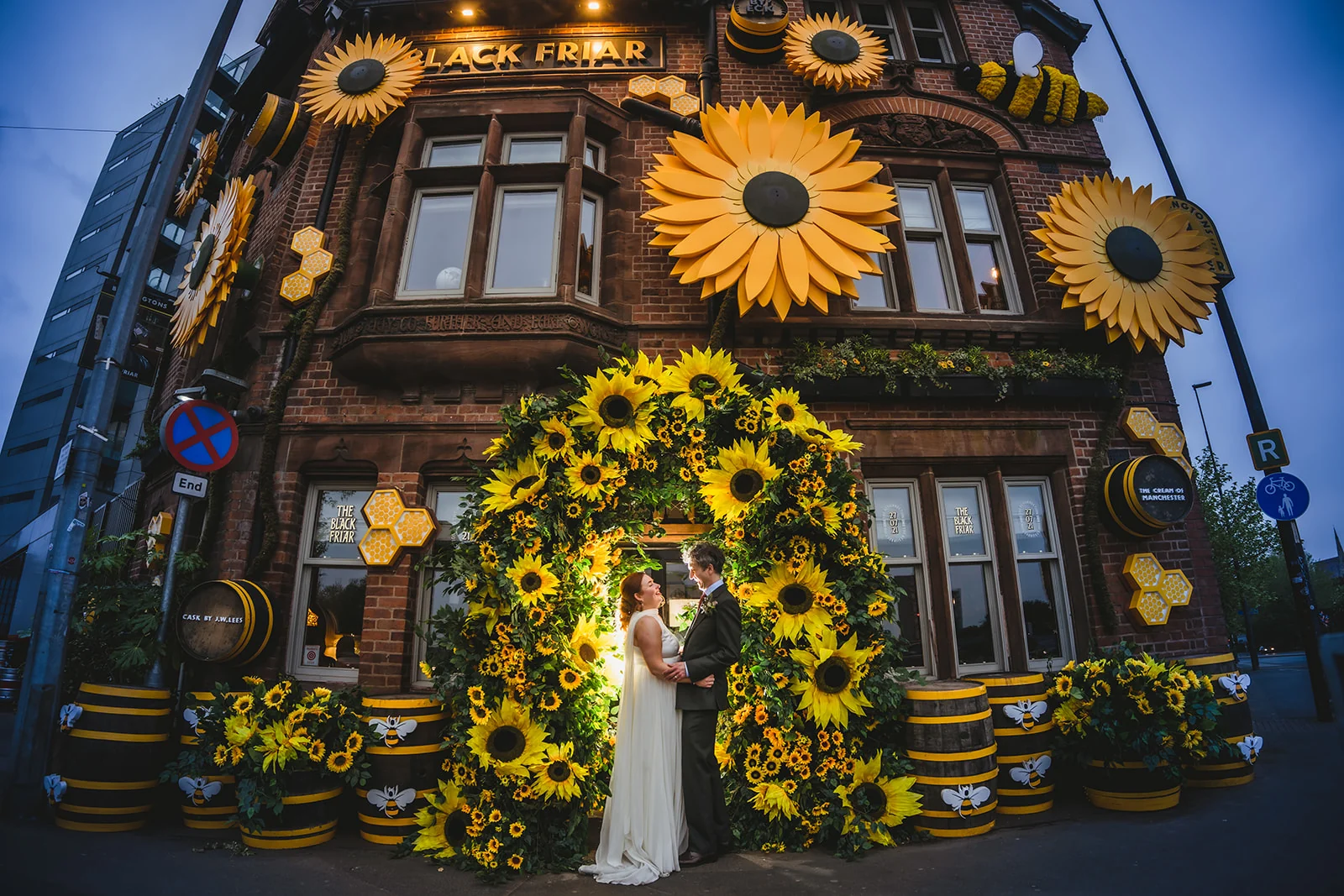 A newly married couple beneath the Black Friar’s spectacular sunflower display